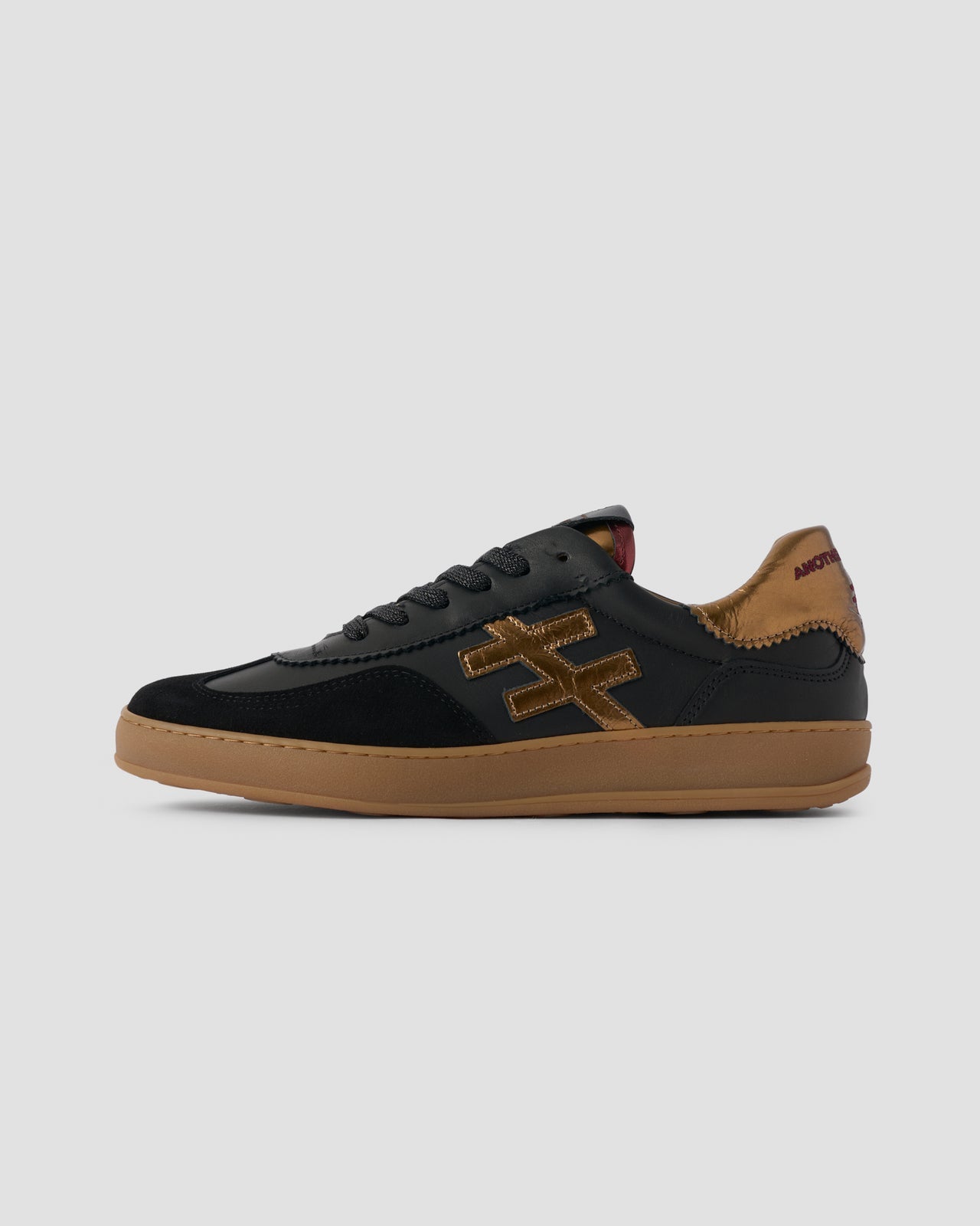 Another Trend black and gold leather and suede sneakers